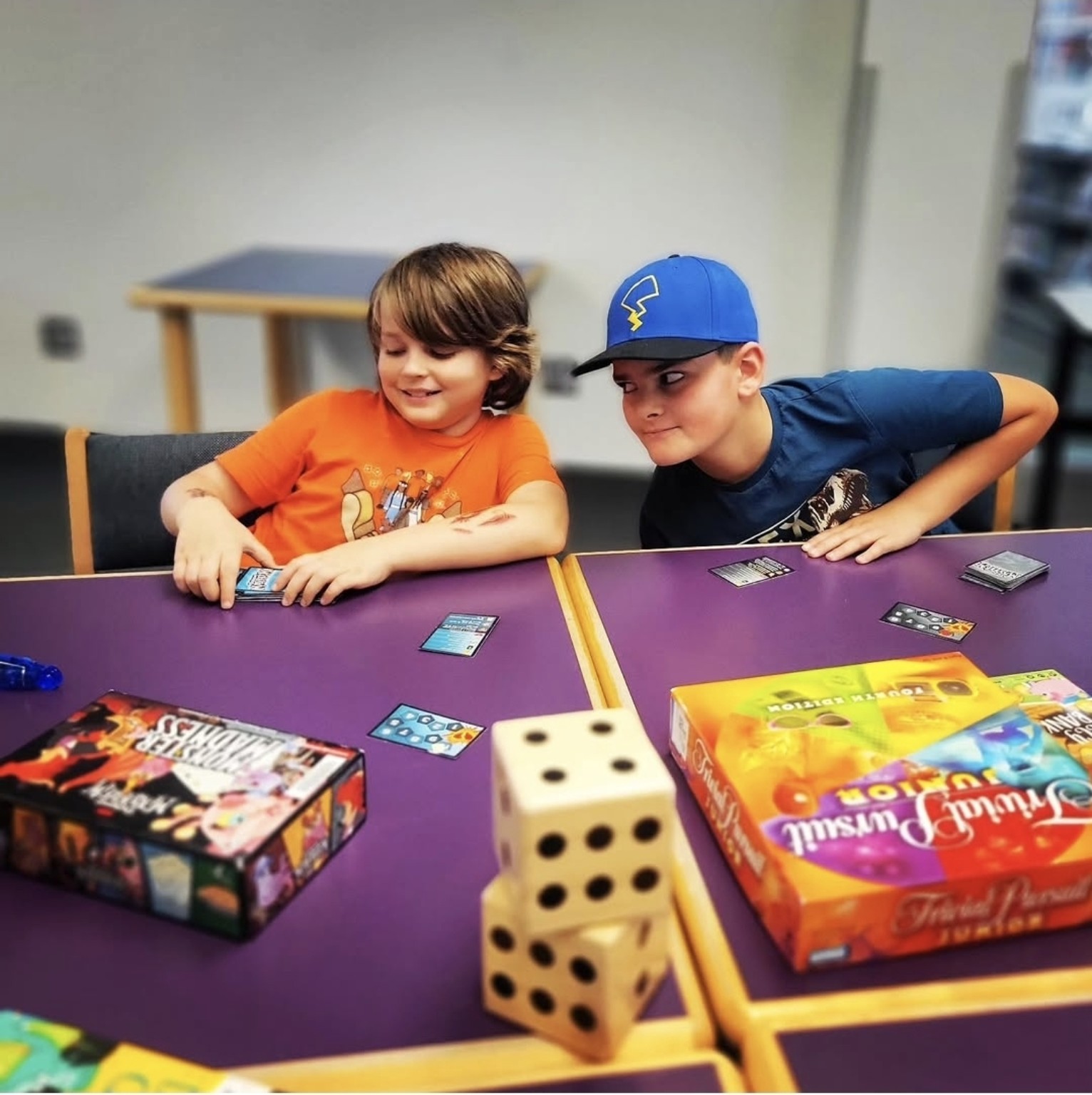 Two Buddy UP! participants smiling together during a card game